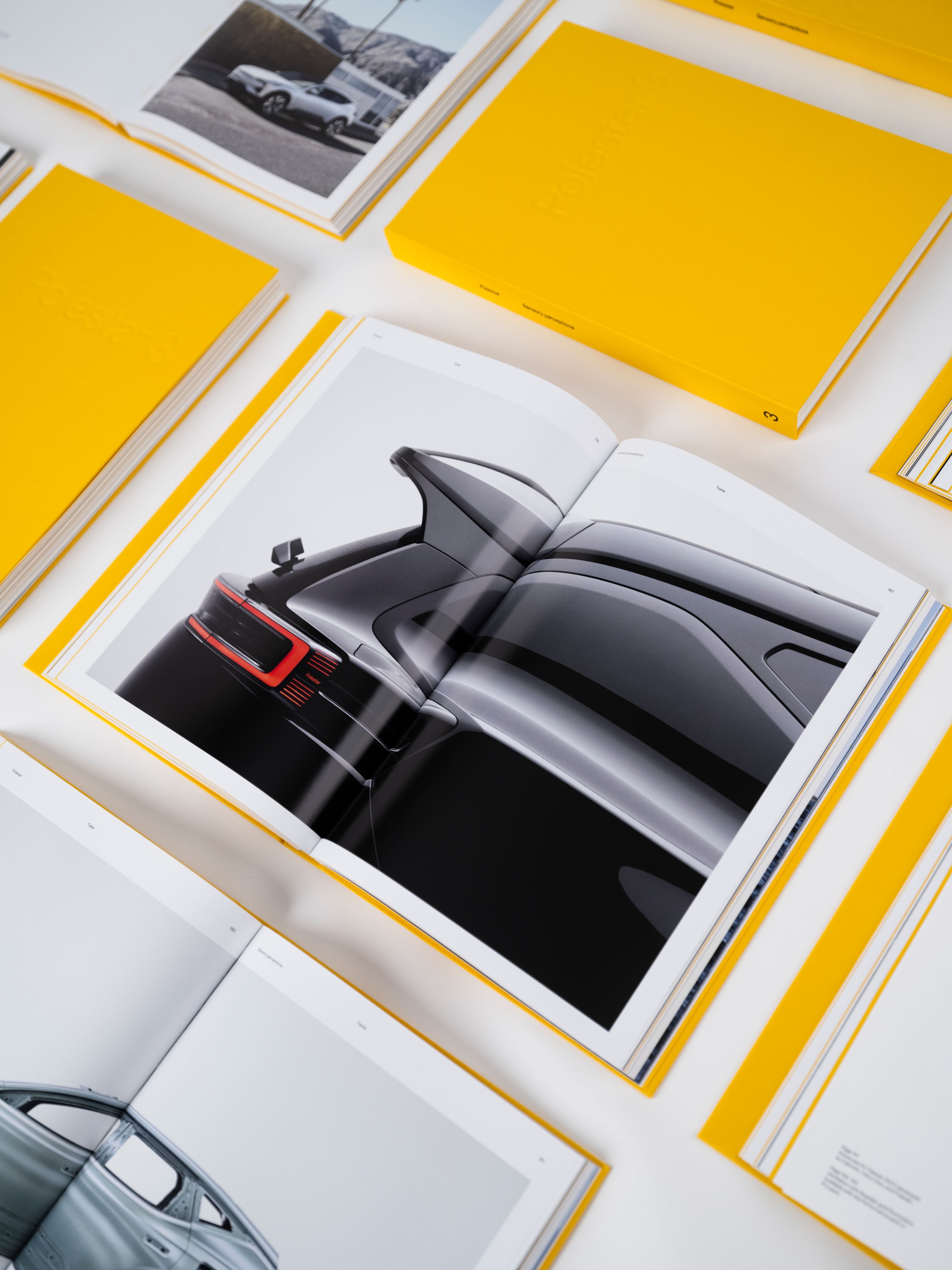 Premium automotive brand book printed with high-resolution imagery and vibrant yellow hardcover packaging, showcasing advanced commercial printing and luxury print finishing. The image highlights precision color reproduction, lay-flat binding, and custom presentation boxes—ideal for corporate publications, product catalogs, marketing collateral, and branded packaging solutions. A strong example of end-to-end multi-solution print and packaging services, from concept and design to production and premium finishing.