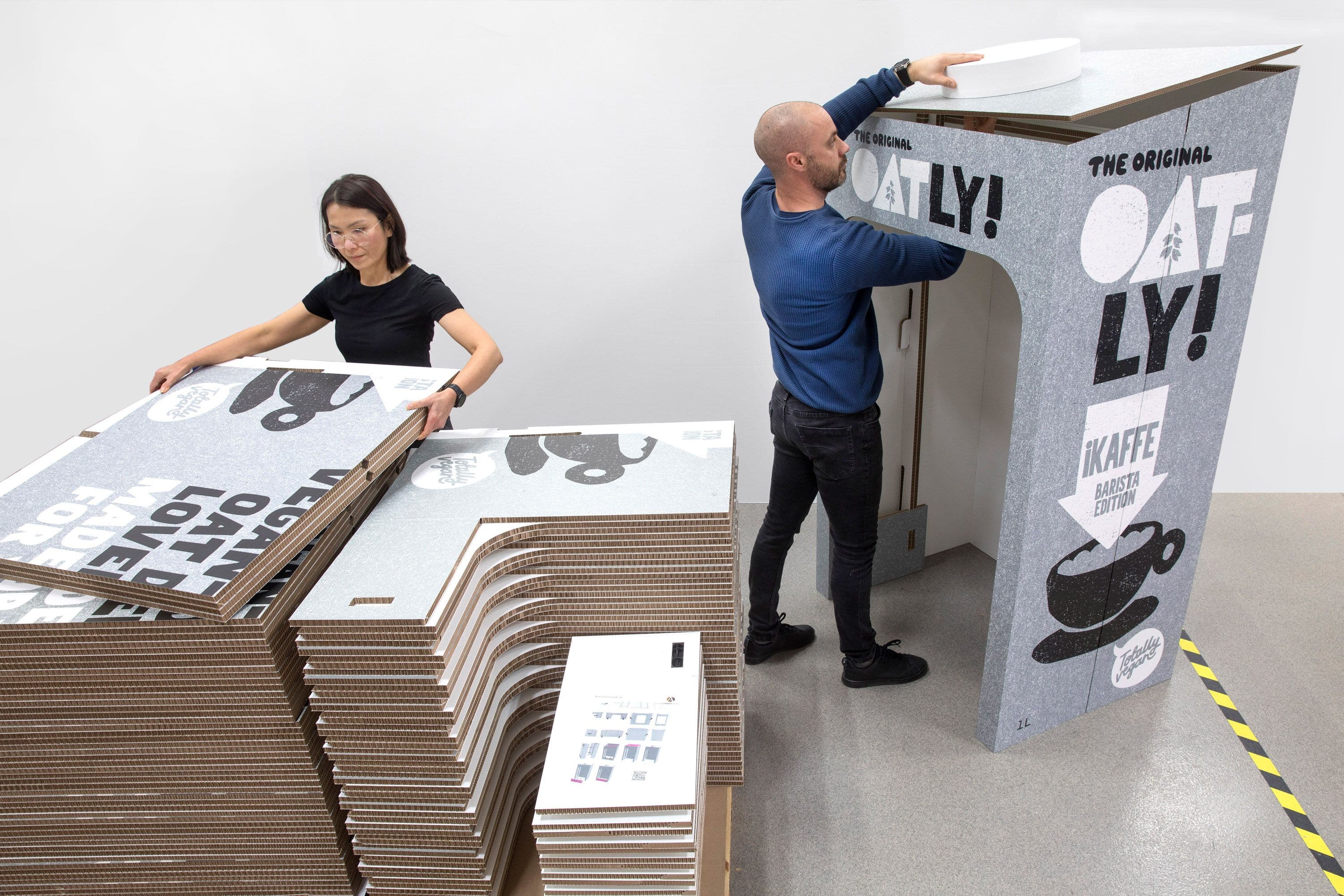 Person building display product in paperboard