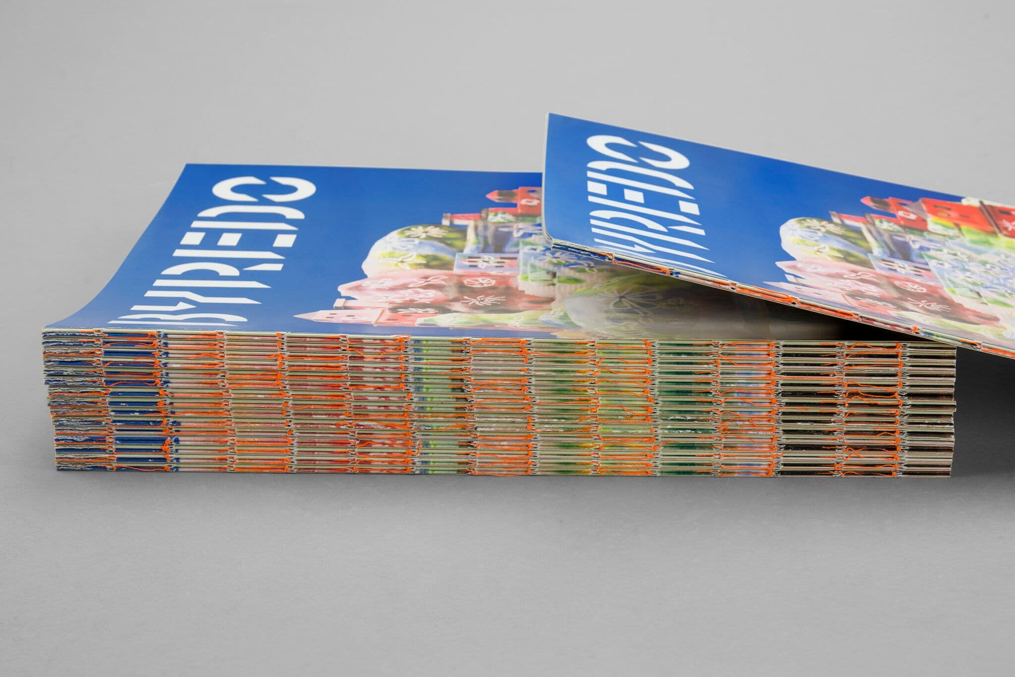 Thread-sewn brochure with orange thread.