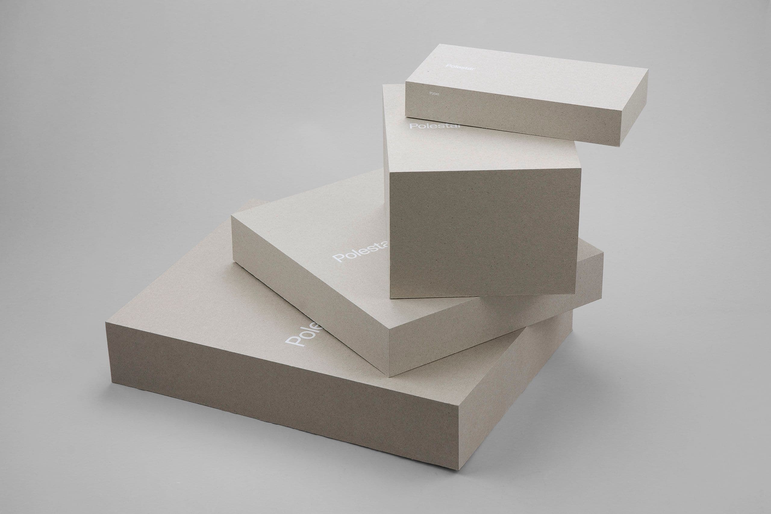 Premium rigid packaging boxes stacked in a minimalist studio setting, showcasing high-end custom print and packaging solutions. The image highlights precision-crafted cardboard boxes with subtle logo branding, clean edges, and luxury finishing—ideal for retail packaging, product presentation, and branded corporate packaging. Perfect example of bespoke box manufacturing, sustainable materials, and premium print production for multi-solution packaging companies.